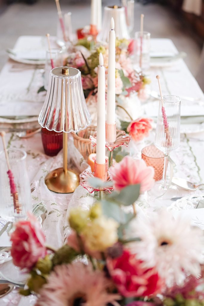 Event table laid with flowers, candles and glassware